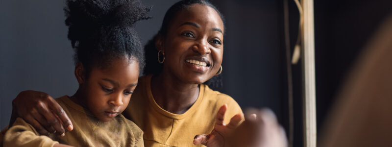 A woman and a girl share a meal.